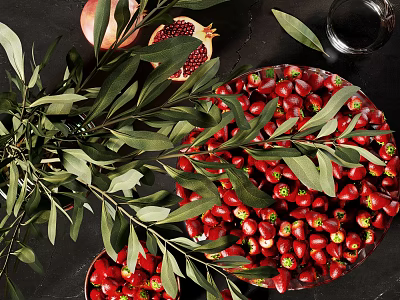 Sliced Pomegranate And Red Fruits Arrangement With Olive Leaves On Dark Table 3d model
