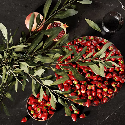 Sliced Pomegranate And Red Fruits Arrangement With Olive Leaves On Dark Table 3d model