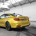 Yellow BMW M4 Coupe Parked In Garage Featuring White Brick Walls High Ceiling Tire Tracks
