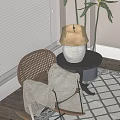 Rattan Leisure Chair with Patterned Blanket Beside Small Round Table and Lamp in Sunlit Room