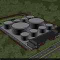 Industrial Plant With Large Storage Tanks Surrounded By Green Trees And Traditional Style Buildings