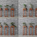 Bonsai Plants Displayed On Red Wooden Plant Stands Against Gray Brick Wall