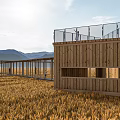 Rustic Wooden Pavilion in Golden Wheat Field with Natural Mountain Backdrop and People