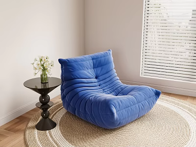 Blue Velvet Bean Bag Chair On Woven Rug With Small Round Table And White Flowers 3d model