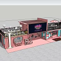 Pink Container Building With Large Wonderland Screen And People In Evening Plaza