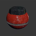 Red Spherical Weapon With Black Hexagonal Top And Textured Surface