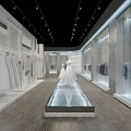 Modern Clothing Store Interior Featuring Glass Cases White Dresses Light Tops Central Platform Recessed Lighting