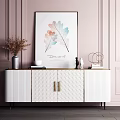 White Console Cabinet With Gold Handles And Decorative Items Against Pink Paneled Wall