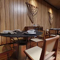 Modern Restaurant Interior With Wooden Walls Macrame Decorations Green Sofa Yellow Chairs Large Windows Plants