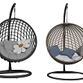 Two Rattan Hanging Chairs with Black and Brown Frames and Comfortable Cushions