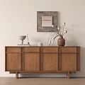 Natural Wood Console Cabinet And Sideboard With Decorative Vase Sculpture Framed Art And Ornamental Details