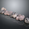 Natural Stone And Wood Decorative Pieces Arranged In A Line On Dark Reflective Surface