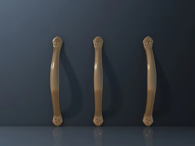 Three Golden Door Handles With Carved Decorations On Dark Gray Wall And Gray Countertop 3d model
