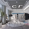 Public Office Space With CF Logo Tripods Cameras Hanging Clothes And Large Potted Plant