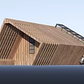 Modern Wooden House Exterior Featuring Geometric Roof Design And Vertical Slats