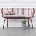 Rose Gold Frame Two-Seater Sofa With Grey Cushions Beige Pink Pillows And Green Plants In Grey Pots