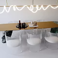 Elegant Golden Dining Table Set With Transparent Chairs White Cushions Marble Base And Curved Chandelier