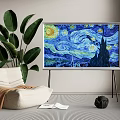 TV Displaying Starry Night Painting With Large Green Plant And Bean Bag Chair
