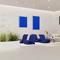 Modern Hotel Public Lounge Area With White Sofas Blue Chairs Wall Art And Green Plants