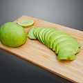 Fresh Avocado Whole and Sliced with Lime on Wooden Cutting Board