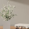 White Square Vase With White Flowers Against Light Colored Wall And White Box