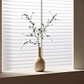 Beige Vase with Green Leafy Twigs on Sunlit Windowsill Against White Blinds