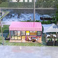 Pink Shipping Container Building Café With Large Windows Outdoor Seating And Palm Tree