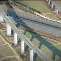 Aerial View Of Interchange Bridge With Multiple Roads Intersecting And Farmland Below