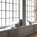 Bright Bay Window Interior With Stacked Books And Blue Vase In Sunlight
