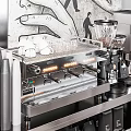 Modern Café Interior With Sleek Metallic Bar Counter And Coffee Brewing Equipment