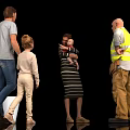 Group of people with man woman child baby and worker interacting in black background