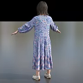 Woman In Blue Purple Floral Long Sleeve Dress Standing With Arms Outstretched On Gray Background