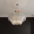 Elegant Crystal Chandelier With Glass Petals Hanging From Decorative Ceiling Against Dark Walls