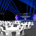 Elegant Banquet Hall With Blue Lighting Stage Logo Round Tables White Tablecloths And Chairs