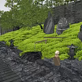 Tranquil Courtyard Garden With Green Plants Stones Path Lanterns Statues And Black Wall