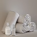 Soft Gray Rolled Towels With Natural Bath Products On Black Surface