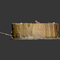 Layered Yellow Cake with Sliced Cream Filling and Petal Toppings on White Plate with Knife