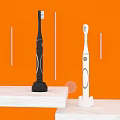 Black and White Electric Toothbrushes on Shelf with Orange Background and White Vase