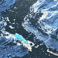 Majestic Snowy Mountain Range With Turquoise Lake And Lush Green Forest