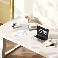 Open Laptop Showing Time on White Desk with Book Camera Magazines and Coffee Cup