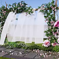 Floral Installation Archway With Green Vines Pink Flowers And White Drapes