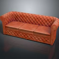 Elegant Orange Quilted Leather Sofa With Rounded Arms And Timeless Design