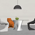 Modern Dining Table Set With Unique White Base White Orange Black Chairs And Green Plant