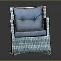 Modern Woven Rattan Chair Featuring Blue Cushion And Brown Comfortable Seat