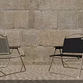 Two Foldable Leisure Chairs With Gray And Black Fabric Metal Frame Stone Wall Background