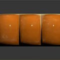 Three Orange Dome Shaped Pastry Desserts With Square Base And Smooth Glossy Surface