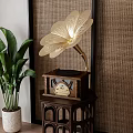 Vintage Gramophone With Decorative Horn On Wooden Stand In Woven Wall Room With Green Plant