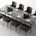 Modern Dining Table Set With Glass Top Eight Grey Chairs Floral Centerpieces And White Plates