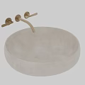 Round Light Colored Textured Stone Wash Basin With Golden Faucet And Double Handles
