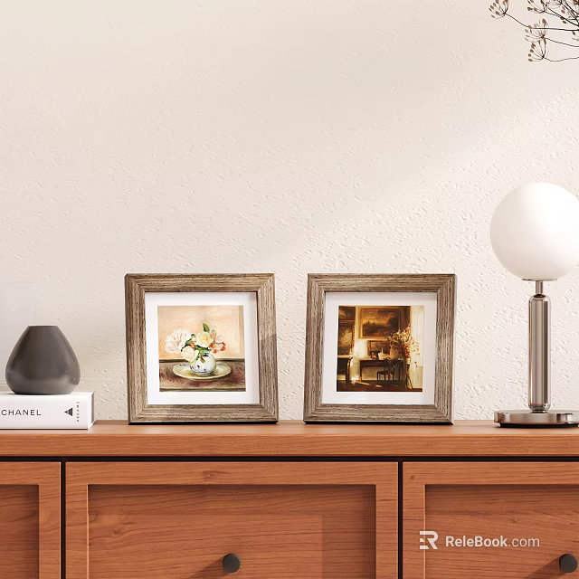 Two Wooden Frames with Floral Art and Interior Scene on Wooden Cabinet with Table Lamp 3d model 